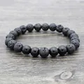 Lava stone and polished black onyx beaded yoga bracelet on a vintage wood background - Shiny Black