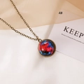 Macro shot of bronze vintage celestial necklace with nebula pattern on cream fabric - Intertwined Red Blue Nebula Style (4#)