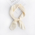 Detail of cream silk scarf with soft satin texture and elegant central knot - Off White