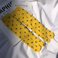 Flat lay of yellow Tabi split-toe socks with blue numbers on Kinfolk magazine background - Yellow