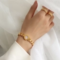 Bracciale in acciaio titanio dorato con numeri romani, inserti in conchiglia e anelli - Oro