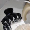 Close-up of a glossy black hair claw clip with a modern minimalist design and mirror finish - Black