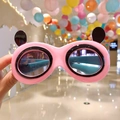 Detailed view of pink heart-shaped kids sunglasses with cute black panda ear decorations - Pink Panda