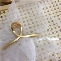 Large golden alloy hair claw clip with a minimalist twisted design for French style hair - Smooth Polished Cross