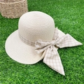 Wide brim straw sun hat with plaid ribbon bow on a green grass outdoor background - M (56-58cm) / Beige