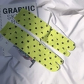 Detail shot of neon yellow Tabi socks with printed black numbers on white fabric - Yellow & Green