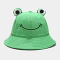 Detailed close-up of green frog bucket hat with 3D eyes and embroidered smile - Green