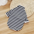 Classic black and white striped cotton puppy vest laying on a natural woven mat - Long Sleeve Black