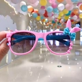 Close-up of pink kids' sunglasses with cute bunny ears and a blue polka dot bow - Pink Rabbit Ears