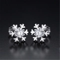 Macro shot of silver snowflake stud earrings featuring central round-cut clear cubic zirconia - Snowflake Solitaire Silver (JED236)