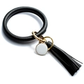 Detail of black leather ring keychain with gold clasp, tassel, and white enamel charm - Solid Black