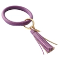 Detailed close-up of purple lychee pattern leather wristlet with tassel and gold ring - Purple