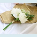 Artificial white peony bouquet with green leaves on vintage newspaper and white cloth - White