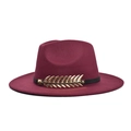 Detail of burgundy wool fedora featuring black leather band and gold metal feather charm - Adult 56-60cm / Burgundy