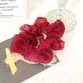 Oversized organza red polka dot scrunchie on a decorative vintage magazine background - Burgundy