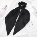 Elegant black satin hair scrunchie with long ribbons on white silk background - Black
