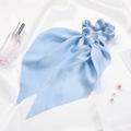 Blue satin silk scrunchie with ribbons shown with perfume and pearls on white silk - Sky Blue