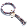 Detail of colorful geometric tie-dye bangle keychain with gold ring and leather tassel - Rainbow Striped