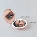 Pink foldable LED travel makeup mirror with 10X magnification and compact round design - 10X Magnification / Sakura Pink