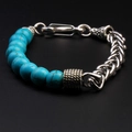 Macro detail of men's tiger stone beaded bracelet with retro stainless steel weave chain - Turquoise
