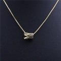 Elegant gold crown necklace with micro-paved blue zircons on black leather background - Black Zirconia / Large Crown / Gold