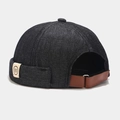 Detail of dark grey denim dock hat showing white woven label and brown leather strap - Adjustable / Black (NH Label)