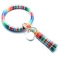 Detail of colorful striped PU leather wristlet keychain with tassel and gold round charm - Rainbow