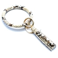 Detail shot of snakeskin texture PU leather bracelet keychain with gold ring and tassel - Snake Print