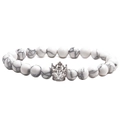 Detailed view of white turquoise beads and a silver crown pendant on a beaded bracelet - White Turquoise White Gold Crown