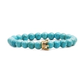 Bohemian turquoise bead bracelet with gold crown charm and white zircon inlays on white backdrop - Blue Turquoise Gold Crown