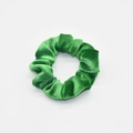 Detailed view of the soft velvet texture and pleats of the green elastic hair scrunchie - Emerald Green