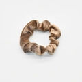 Close-up of velvet scrunchie texture in brown fabric with soft pleats on white background - Beige Brown