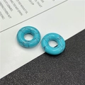 Macro detail of turquoise-colored natural stone beads with black marble patterns - Synthetic Blue Turquoise