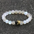 Detail of beaded moonstone bracelet with gold crown charm on black glitter backdrop - Moonstone Crown B
