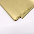 Detail of premium gold tissue paper with soft texture and glossy finish for gift wrapping - Gold