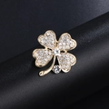 Golden clover brooch with white rhinestones and pearls on black leather background - Gold Full Diamond Clover