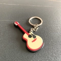 Creative PVC soft rubber guitar keychain with red and beige finish on dark background - Acoustic Guitar