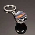 Silver keychain with a double-sided galaxy glass orb featuring cosmic star patterns - Milky Way