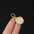 Golden evil eye earring featuring a textured oval pendant with blue and white enamel - Hammered Oval Eye (15#)