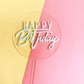 Close-up of a clear acrylic round cake topper with white Happy Birthday lettering - Acrylic / Blue