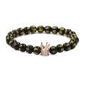 Detailed shot of black beads with gold runes and a rose gold crown charm with zircons - Six-Word Mantra Rose Gold Large Crown / Rose Gold