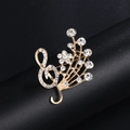 Elegant gold music note brooch with crystal rhinestones and flower detail - Radiant Music Note Gold (XD9119-1)