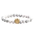 Close-up of white turquoise marble beads and a gold crown charm on a beaded bracelet - White Turquoise Gold Crown