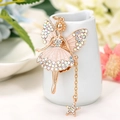 Close-up of golden fairy keychain with colorful rhinestones and a star pendant - White