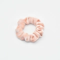Detailed texture of pink velvet scrunchie showing glossy fabric and elastic design - Hot Pink