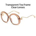 Trendy tea-colored oval sunglasses with pearl-accented golden wavy metal temples - Transparent Brown Frame Transparent Lens