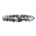 Macro view of white zebra jasper stone beads with a gun black zircon crown charm - White Malachite Gun Black Crown