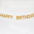 Glittering gold Happy Birthday banner hanging on white brick wall for party decor - Glitter Paper Solid Gold