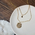 Double-layered 18K gold plated titanium necklace with sun and coin pendants on ceramic - Roman Star Double-Layered Necklace