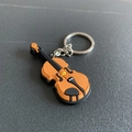 Cartoon violin soft PVC keychain with silver metal ring in orange and brown tones - Violin